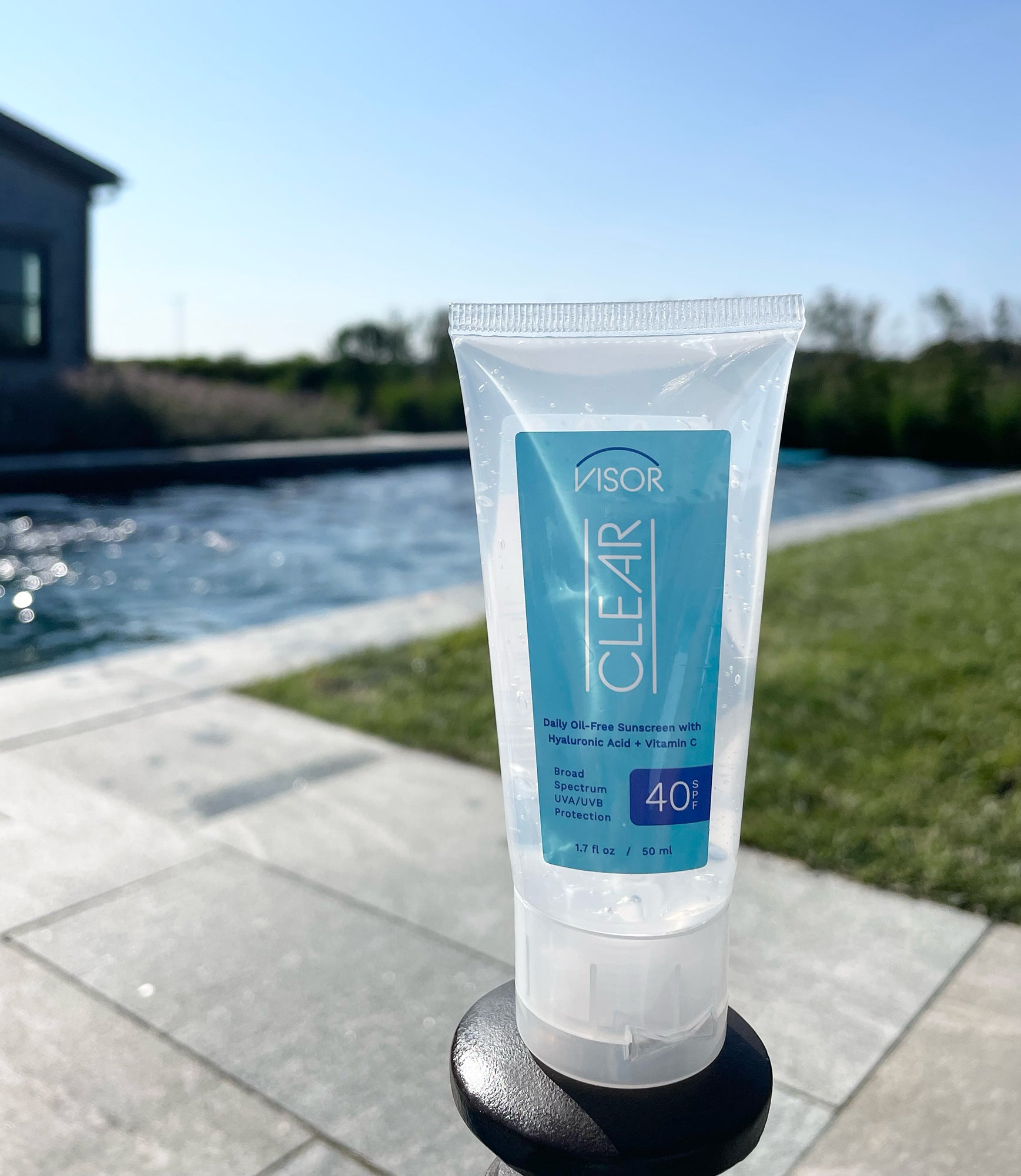 Sunscreen tube with pool in background