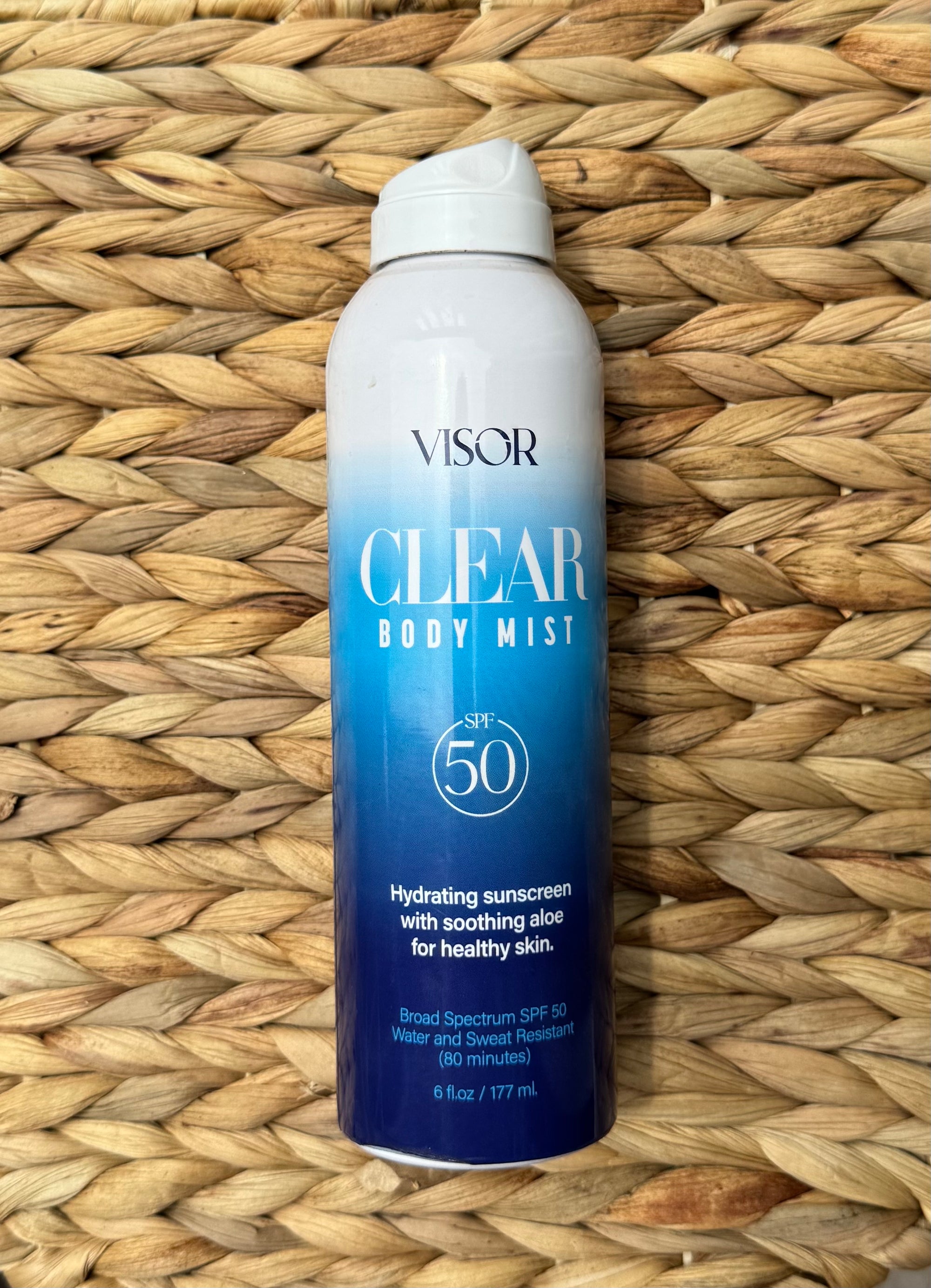 Visor Clear Body Mist SPF 50 on a blurred natural background